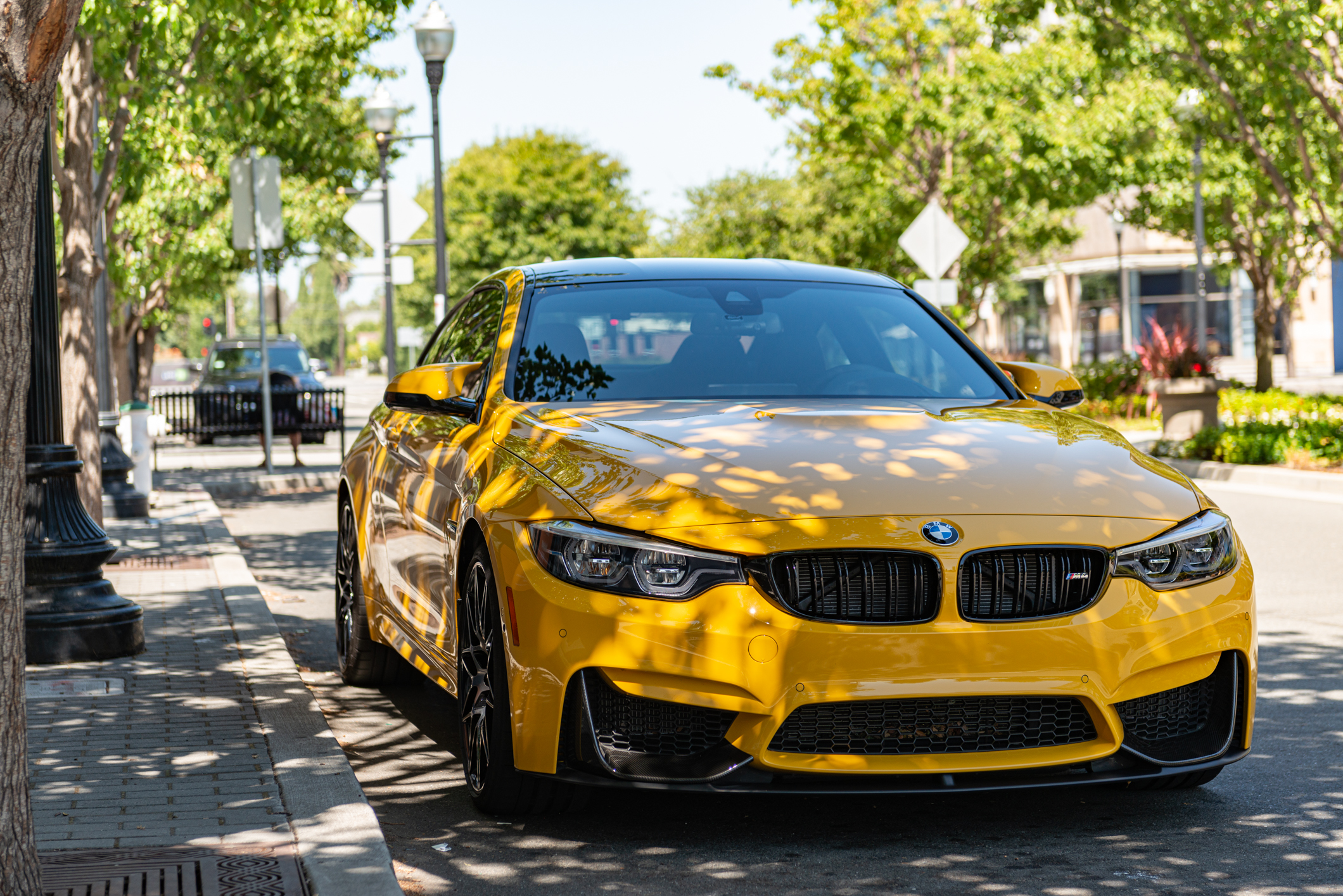 Photo of yellow BMW M4 in the shade